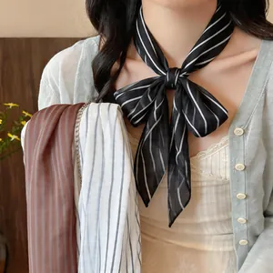 Detailed view of stylish striped neck scarves in black, brown and white colors