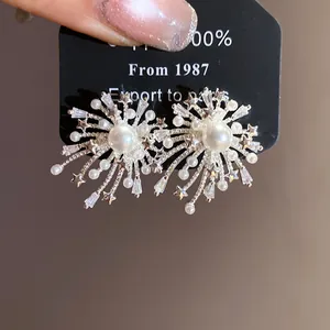 Detail view of firework zircon pearl earrings with elegant starburst pattern.