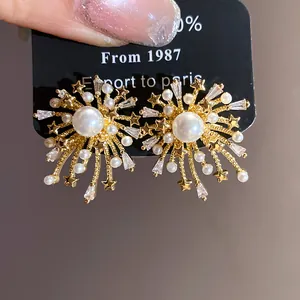 Close-up detail of firework-style stud earrings with pearls and shimmering zircons