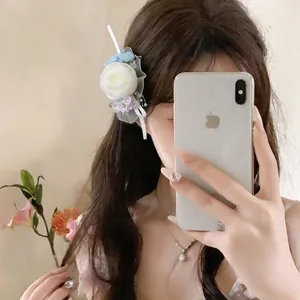 Delicate chiffon rose hair clip in mori style worn by model in a mirror selfie detail