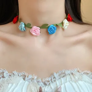 Close-up of a colorful ribbon rose flower choker necklace in vibrant dopamine style.