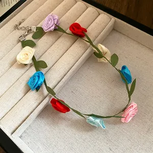 Detail view of a colorful ribbon flower choker necklace displayed in a jewelry box.