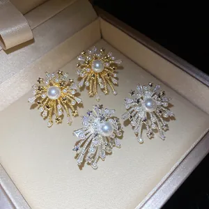 Detailed view of firework-style earrings with pearls and zircon in a jewelry box
