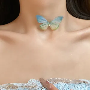 Close-up view of a soft gradient blue and yellow butterfly choker worn on the neck