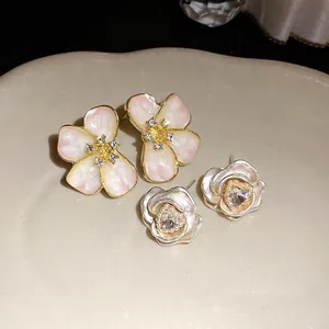 Elegant pink and white floral earrings with sparkling crystals for a luxury look.