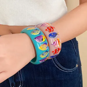 Colorful resin bangles with tropical fish prints for beach resort style fashion