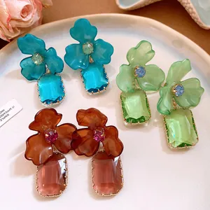 Detailed view of floral acrylic earrings with rectangular crystal drops in various colors