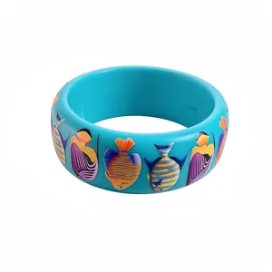 Ocean themed resin bangle with colorful tropical fish prints on turquoise background