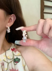 Elegant French style hoop earrings with shimmering pearls and cubic zirconia details.