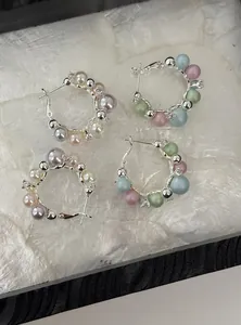 Elegant silver hoop earrings featuring pastel and neutral pearl accents with sparkling zircons.