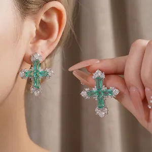 Elegant silver cross earrings with green emerald-cut stones and cubic zirconia accents