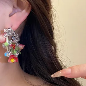 Sweet silver needle flower hoop earrings featuring colorful glass beads on a model