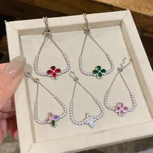Detailed view of five floral zircon bracelets in various colors arranged in a tray