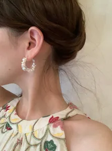 Exquisite French style pearl and zircon hoop earring shown on a model for a lifestyle look