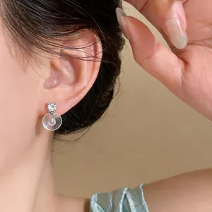 Close-up view of an elegant 18k gold plated silver stud earring with zircon shown on ear