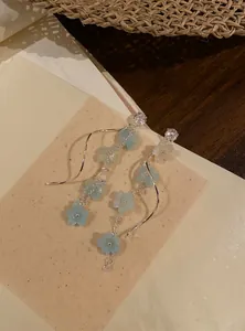 Elegant long tassel earrings featuring zircon studs and blue floral petal details