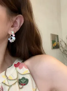 Detailed macro shot of French luxury colorful pearl and zircon hoop earrings for women