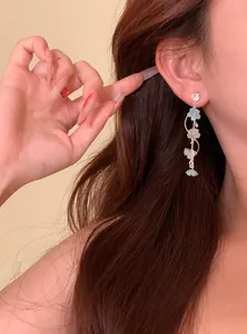 Elegant long tassel earrings featuring light blue zircon flowers worn by a model in a lifestyle view