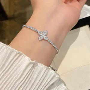 Detail view of silver-tone flower bracelet with marquise-cut clear zircons on wrist