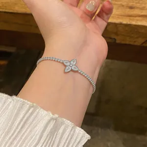 Elegant zircon flower bracelet in silver finish beautifully worn on a woman's wrist