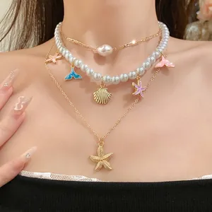 Elegante collana di perle a più strati con ciondoli a forma di stella marina e pesce