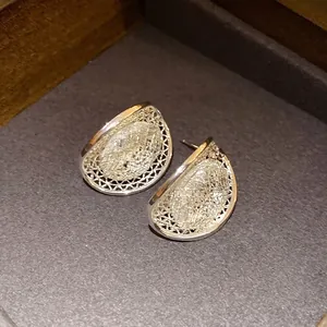 Elegant silver mesh hollow oval stud earrings in French light luxury style for women