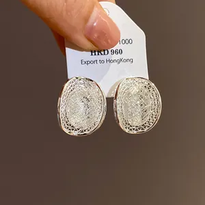 Detailed view of silver mesh hollow oval stud earrings with elegant French style