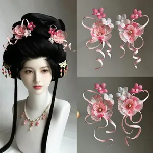 Detailed view of pink chiffon flower hair clips with elegant ribbon tassels for Hanfu style.