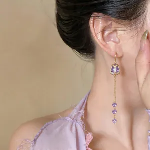 Close-up of elegant purple tulip zircon tassel earrings with 18k gold plating.