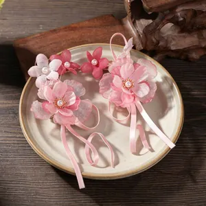Exquisite detail of pink chiffon flower hair clips featuring elegant satin ribbon tassels