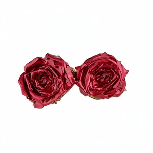 Elegant metallic red rose stud earrings with a glossy finish for a chic and feminine look.