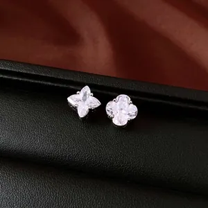 Asymmetric silver stud earrings with zircon flower and star clover design