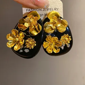 Vintage resin flower stud earrings featuring elegant gold metallic floral ornaments