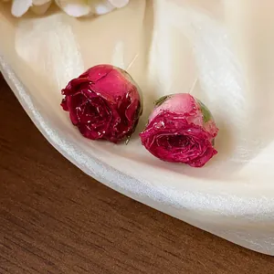 Close-up shot of exquisite real rose petal stud earrings with 925 silver needles for women