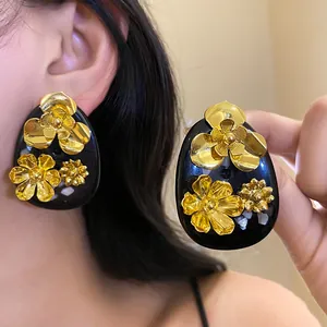 Vintage black resin teardrop earrings with golden flowers detail view for women