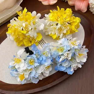 Elegant handmade fabric flower hair clips in yellow and blue floral clusters.