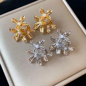 Elegant vintage-style floral pearl stud earrings in gold and silver finishes