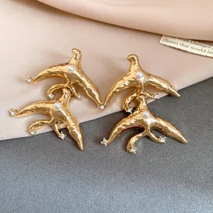 Detailed view of vintage gold geometric earrings with pearls and crystal accents