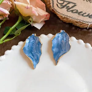Elegant vintage exaggerated blue marble texture leaf earrings with stylish gold trim design