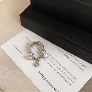 Detailed view of silver double-layered ear cuff with zircon star charm pendant