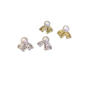 Minimalist 18K gold and silver plated bow stud earrings featuring elegant white pearls