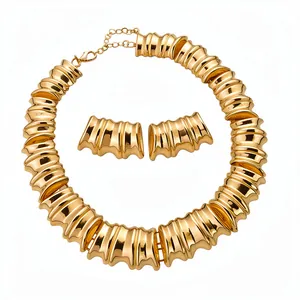 Vintage gold-tone metal textured necklace and earrings set with elegant ribbed wavy design