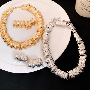 Detailed macro view of metallic ribbed jewelry set with necklace and stud earrings