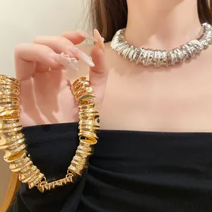 Detailed close-up showing the rich texture of gold and silver chunky metal choker necklaces