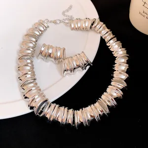 Detail view of chunky silver textured metal necklace and matching stud earrings set