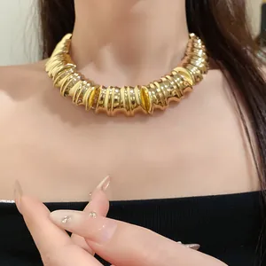 Detail view of chunky gold-toned textured choker necklace for a vintage luxury look