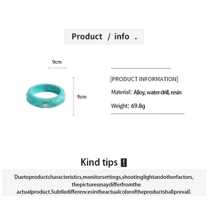 Detailed view of turquoise marbled resin bangle with rhinestone inlay and specifications