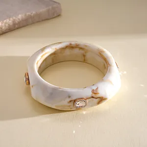 Detail of vintage resin bangle with marble effect and sparkling rhinestone accents.