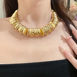 Detailed close-up of a vintage-style gold ribbed chunky metallic choker necklace