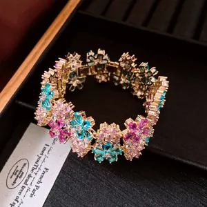 Close-up of luxury 18k gold plated flower bracelet with pink and blue zircons
